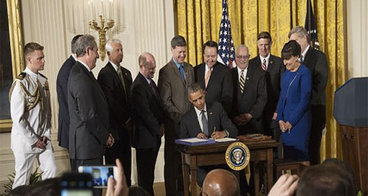 US President Obama signing the AGOA Trade Extension Act of 2015 into law.