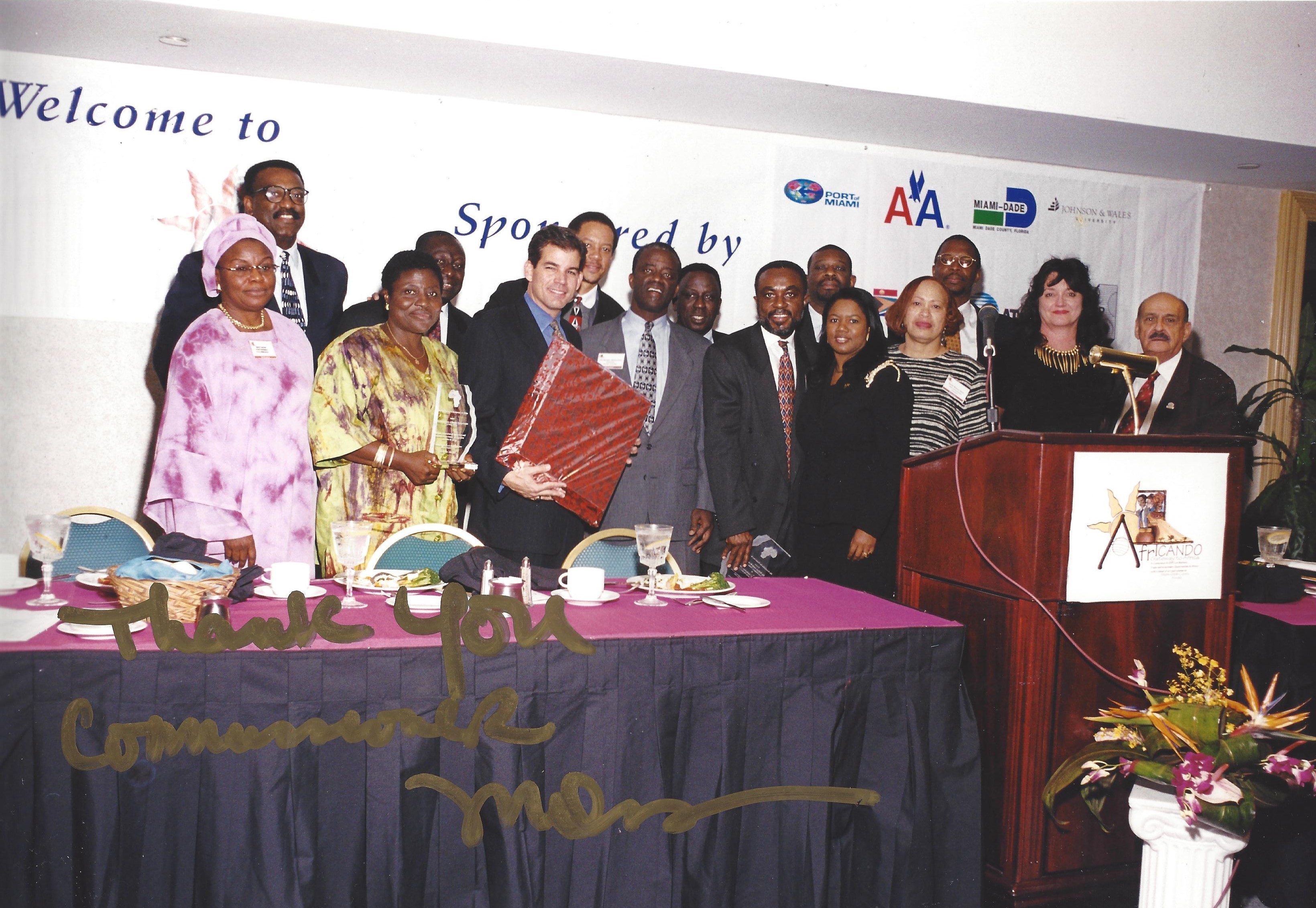 Commissioner Dennis Moss, Fred Oladeinde and AfrICANDO attendees pose for picture